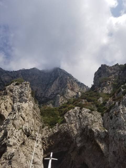       Upside-down view of rocky cliffs and sky.
  