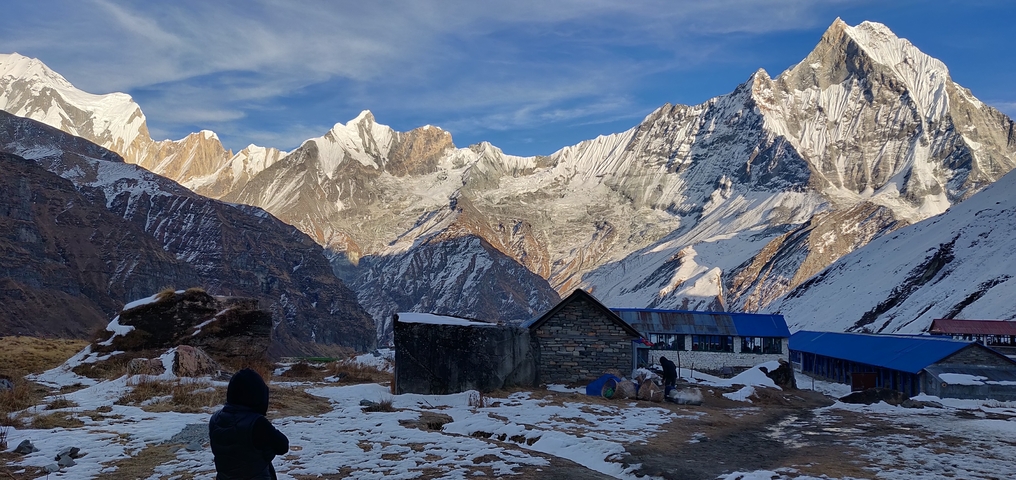Snowy mountain view with lodges in the foreground.