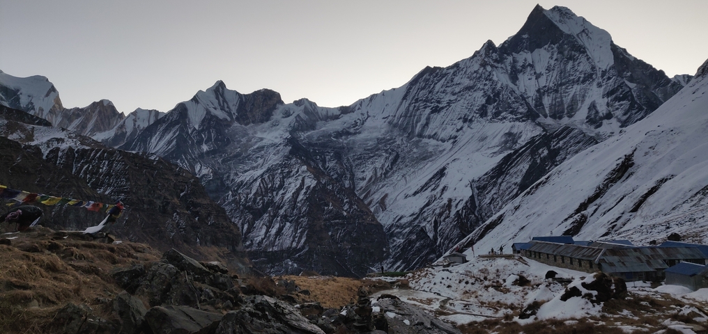 Snow-covered mountains with prayer flags.
