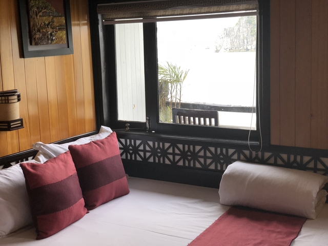       A cozy bed with a view from the window.
  