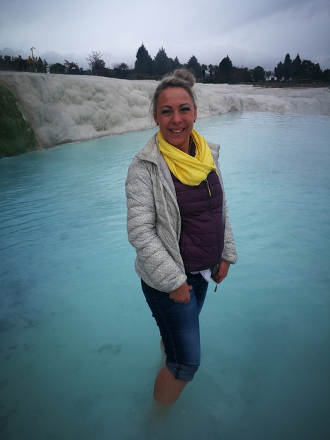 Person standing in clear blue water.