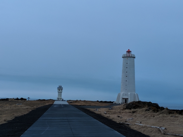       Two lighthouses in a barren landscape.
  
