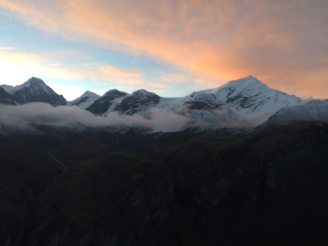 Snow-capped mountains with a vibrant sky at dusk.