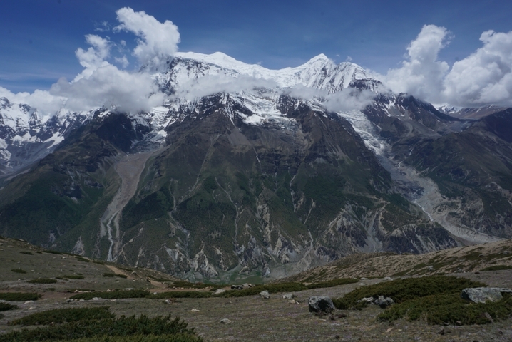 Majestic mountain range with snow-covered peaks under a clear sky.