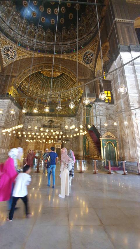 Lavish mosque interior with ornate details.