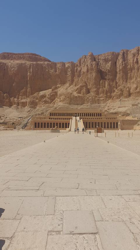 Temple façade in rocky desert setting.