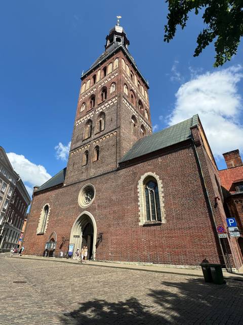       A tall church tower on a sunny day.
  