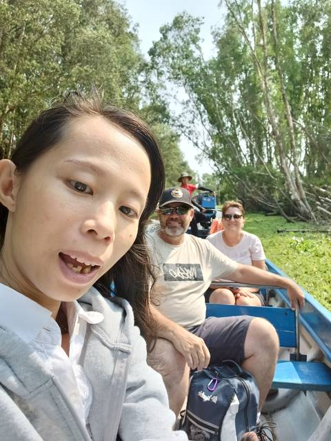 People taking a selfie in a boat.
