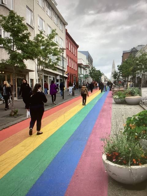 Brightly colored pedestrian street with people walking.