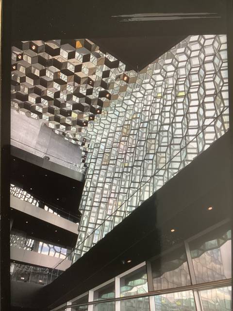 Interior of a modern building with geometric ceiling design.