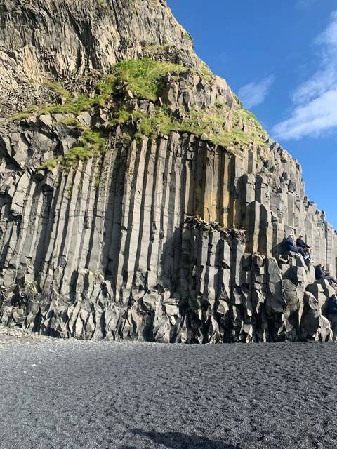 Basalt columns against a blue sky.