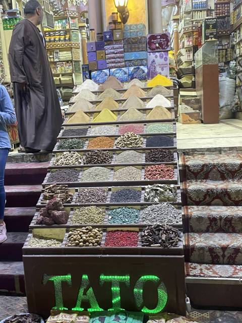 Market stall displaying spices and goods.
