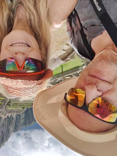       Couple selfie with mountains in the background.
  
