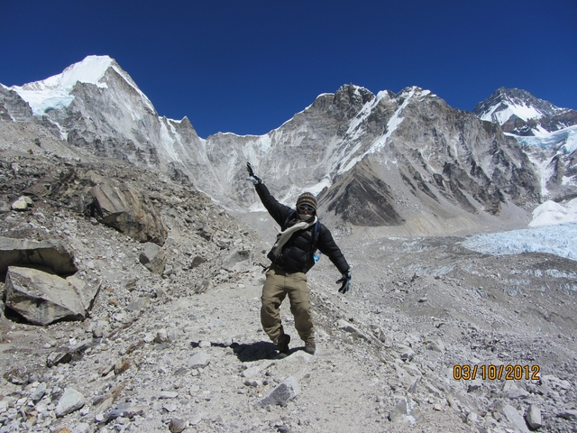       Person posing with mountains in the background.
  