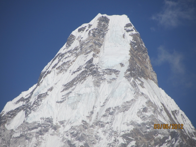       Snow-capped mountain peak with clear sky.
  