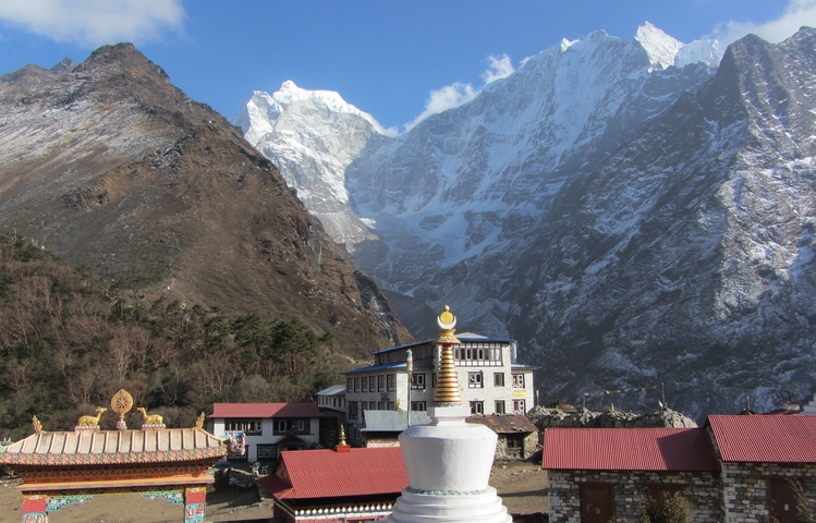       Monastery with mountains in the background.
  
