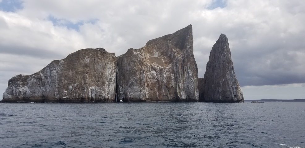 Dramatic rock formations rising from the ocean.