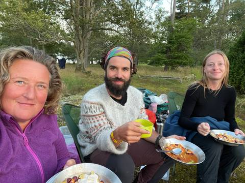 People sitting and eating a meal outdoors.