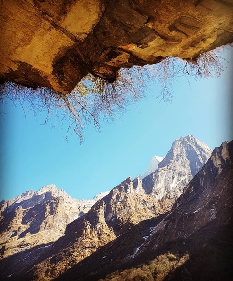       Mountain peaks against a clear blue sky.
  
