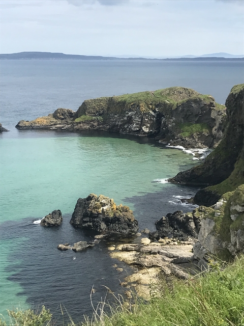 Turquoise bay surrounded by rocky cliffs.