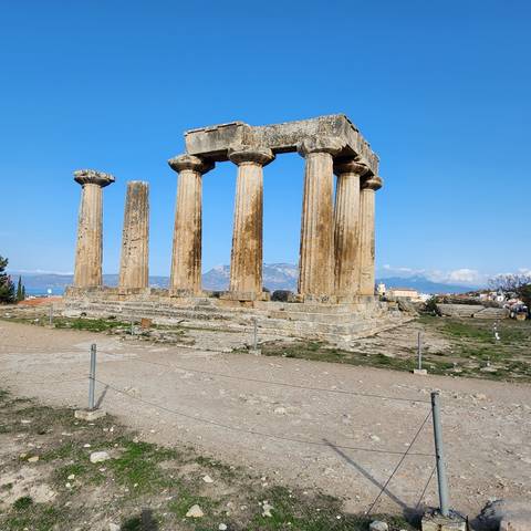       Ancient Greek temple ruins with columns.
  