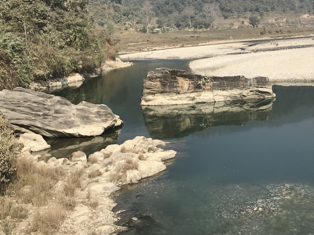       River with large rocks and reflections.
  