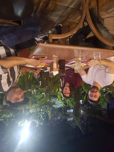 People dining outdoors at night.