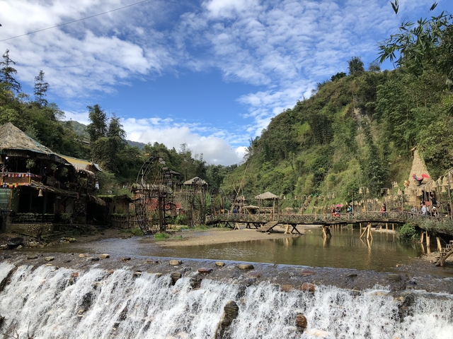 Rustic village with traditional architecture and a small river.