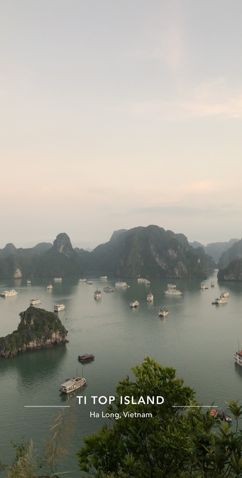 Boats on the water surrounded by limestone islands.