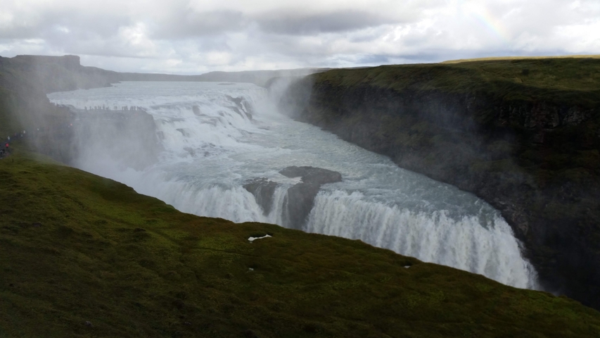 Majestic waterfall among lush greenery.