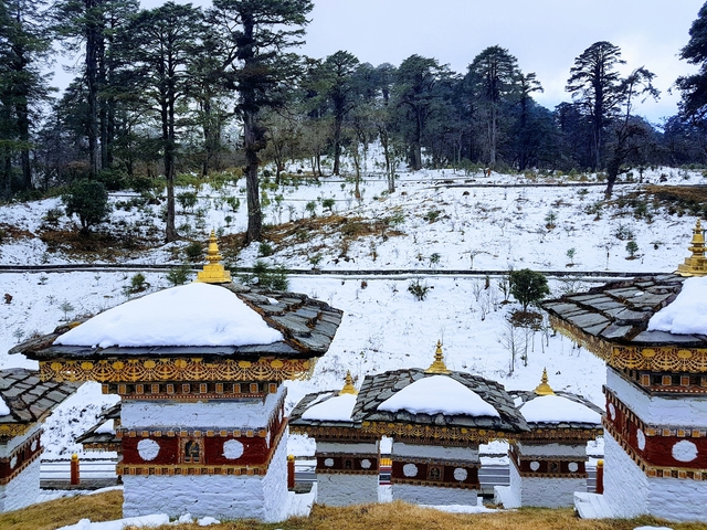 Decorative stupas on a snow-covered landscape.