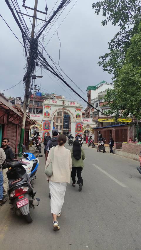 Street with people walking and vehicles.