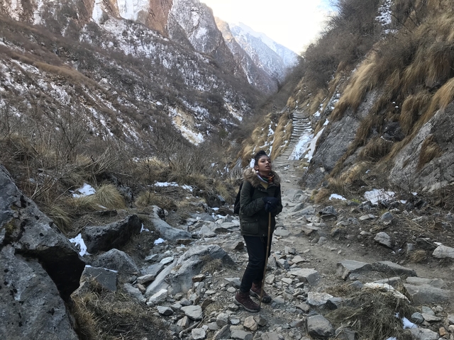      Person on a rocky mountain path.
  