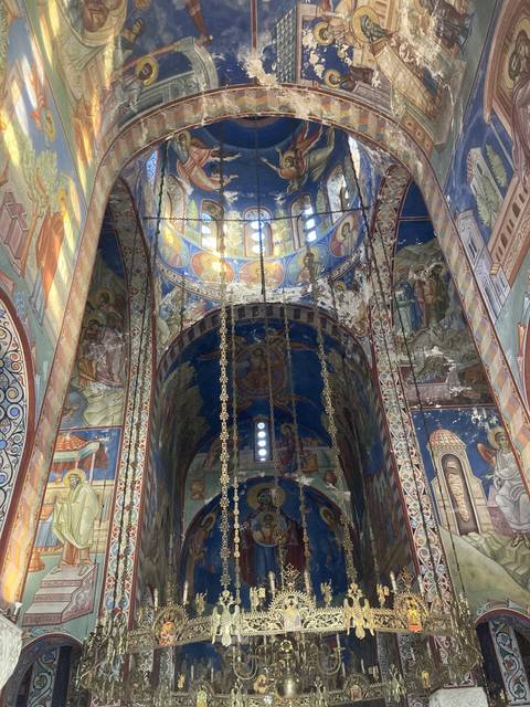 Ornate church ceiling with mural paintings.
