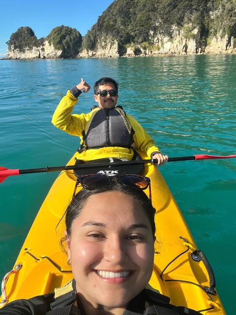       A couple in a kayak on a bright sunny day.
  