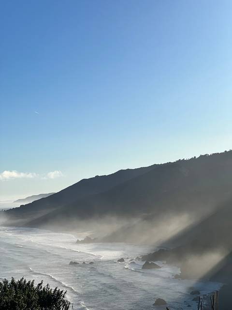       A view of ocean waves crashing against a rocky shore.
  