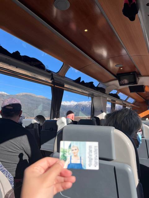       A view from inside a bus with passengers on board.
  