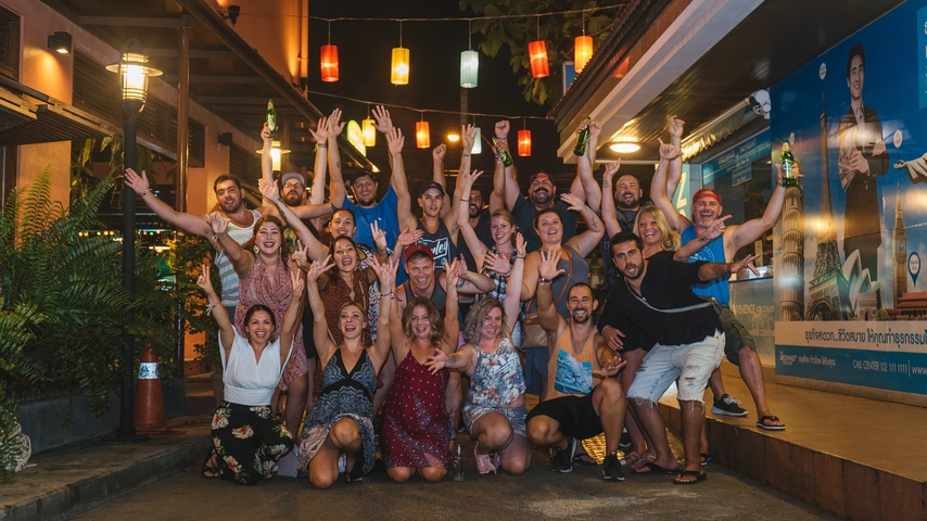 Group of people celebrating and posing at night.