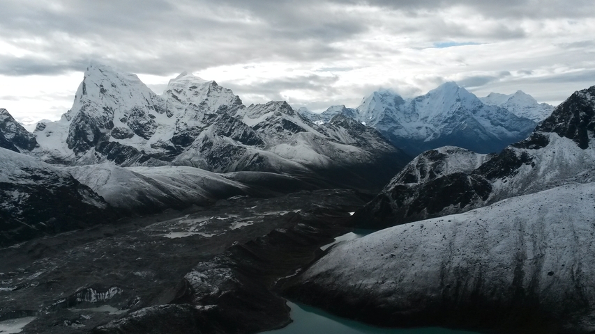 Vast mountainous landscape with visible glaciers.