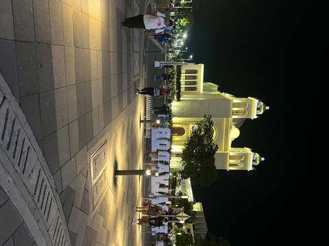 Church with people in front at night.