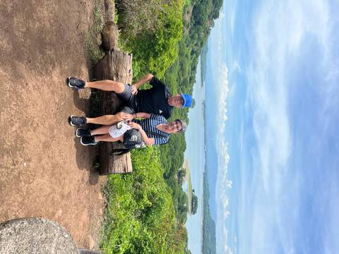 Couple sitting on a bench with a scenic view.