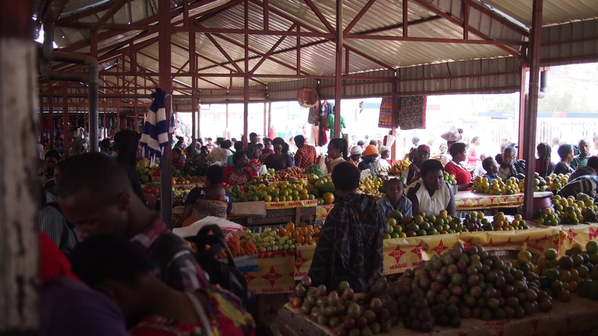       Crowded market with fruits and vegetables.
  