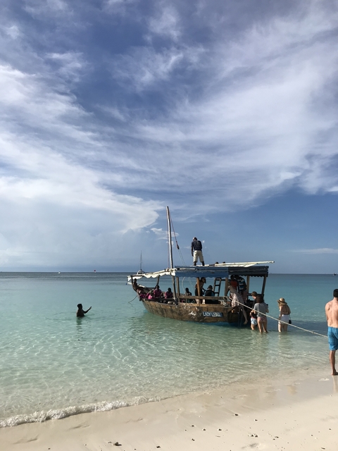 People on a boat in clear blue water.