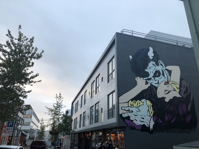       Street art mural on a building in an urban area.
  