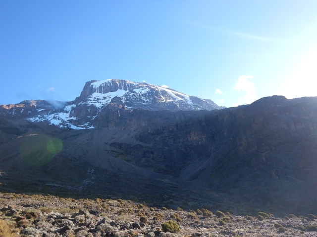       Distant snowy mountain peak under clear sky.
  