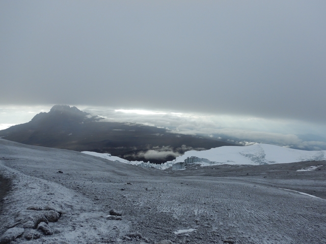       Scenic mountain landscape with snow and cloud cover.
  