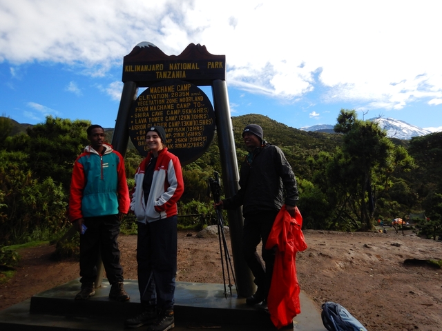       Three people posing at Machame Camp in Kilimanjaro National Park.
  