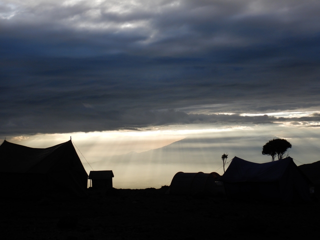       Majestic landscape view with the sun breaking through clouds.
  
