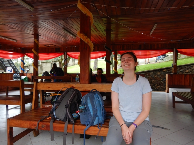       Person relaxing in an indoor area with backpacks.
  