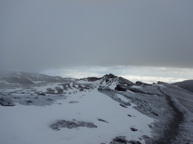       Snow-covered mountain landscape with overcast sky.
  